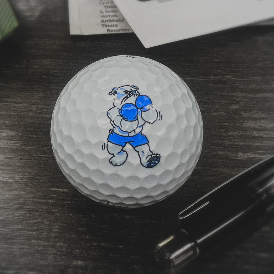Golf ball with a cartoon bulldog on a dark surface small remaster and vectorization