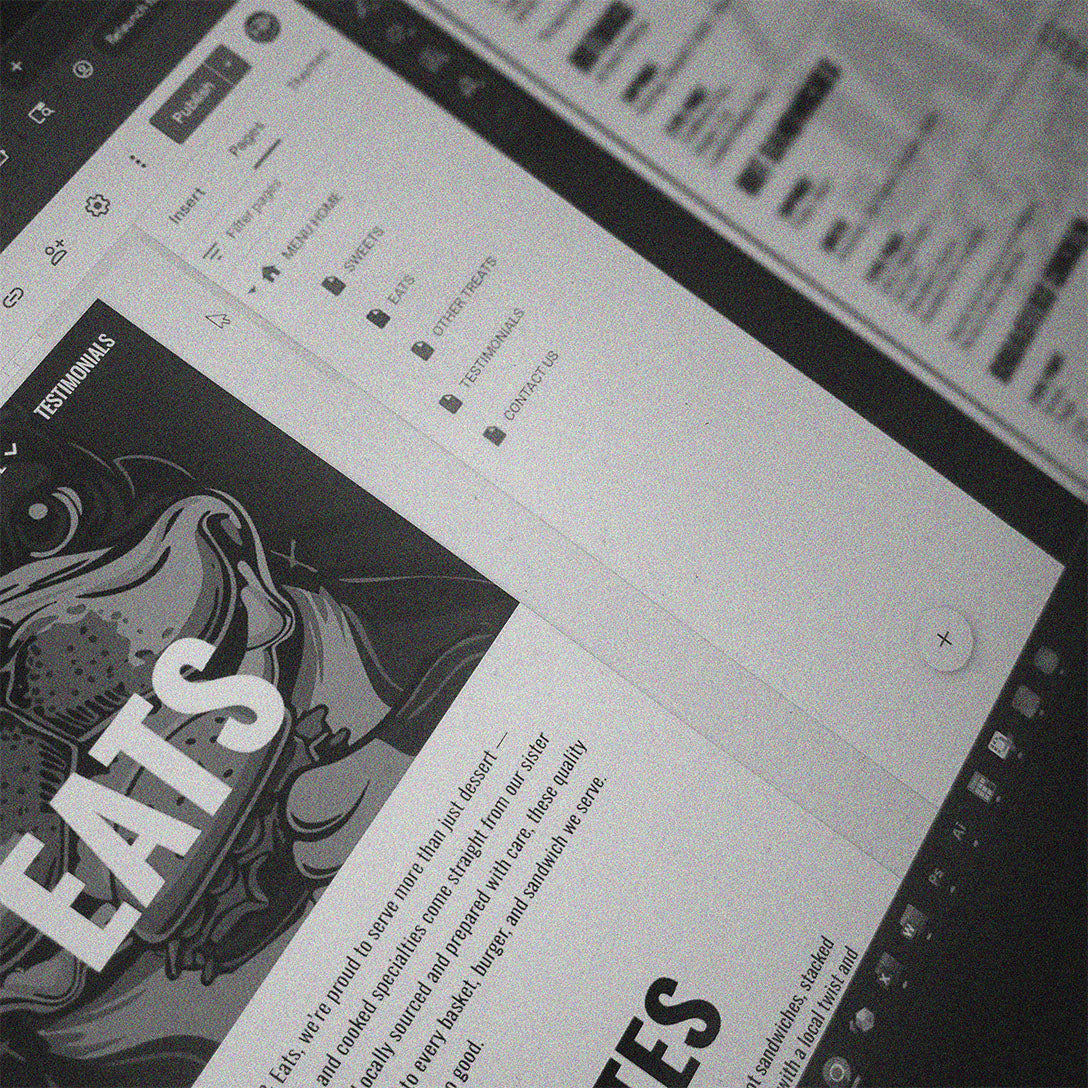 Close-up of a tablet screen displaying a website with a graphic design on the left side by HD Designs LTD